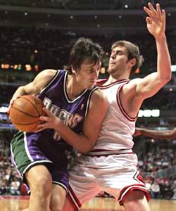 Australian Andrew Bogut attempts a move on Argentine Andres Nocioni